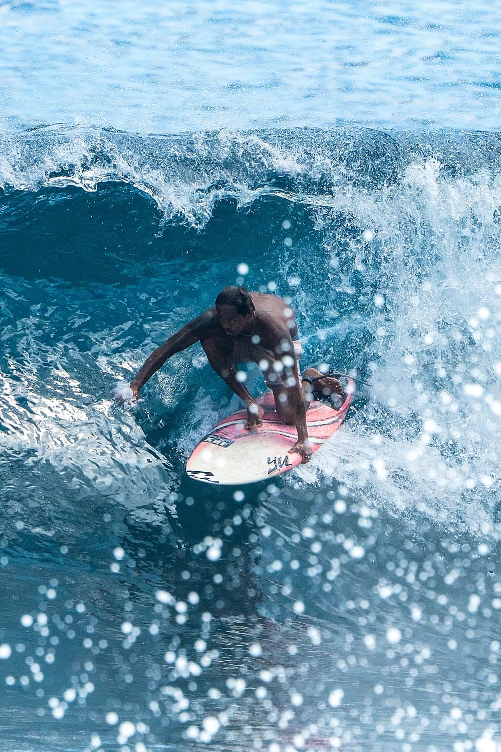 Surfer carving deep in the pocket of a wave at Cloud 9, Siargao