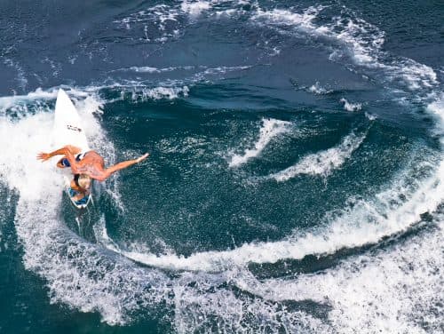 Aerial view of surfer carving a turn